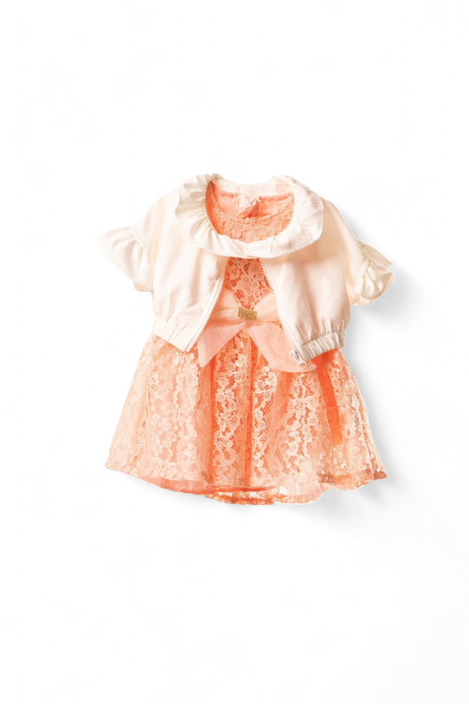 Peach lace baby girl dress with a white ruffled bolero and a large bow accent on the front.