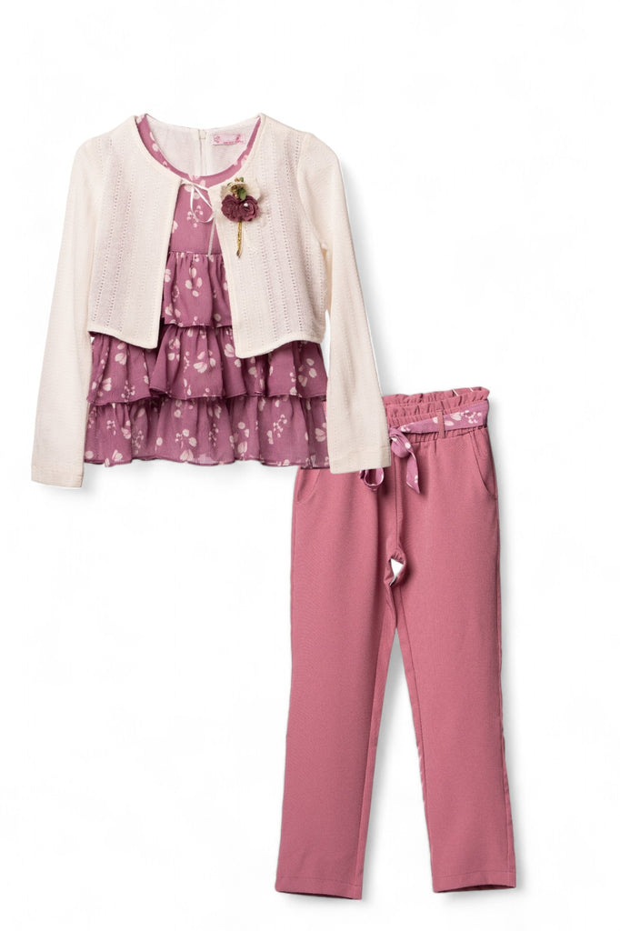 Senior girl wearing a stylish bolero set consisting of a white jacket, a ruffled blouse, and purple trousers.