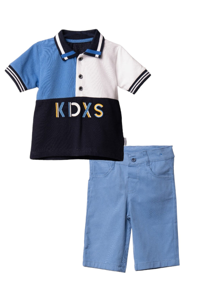 A stylish boy's casual outfit consisting of a blue polo shirt with black and white panels, paired with blue shorts.